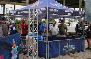 Several people around a Redfish Holding Tank.